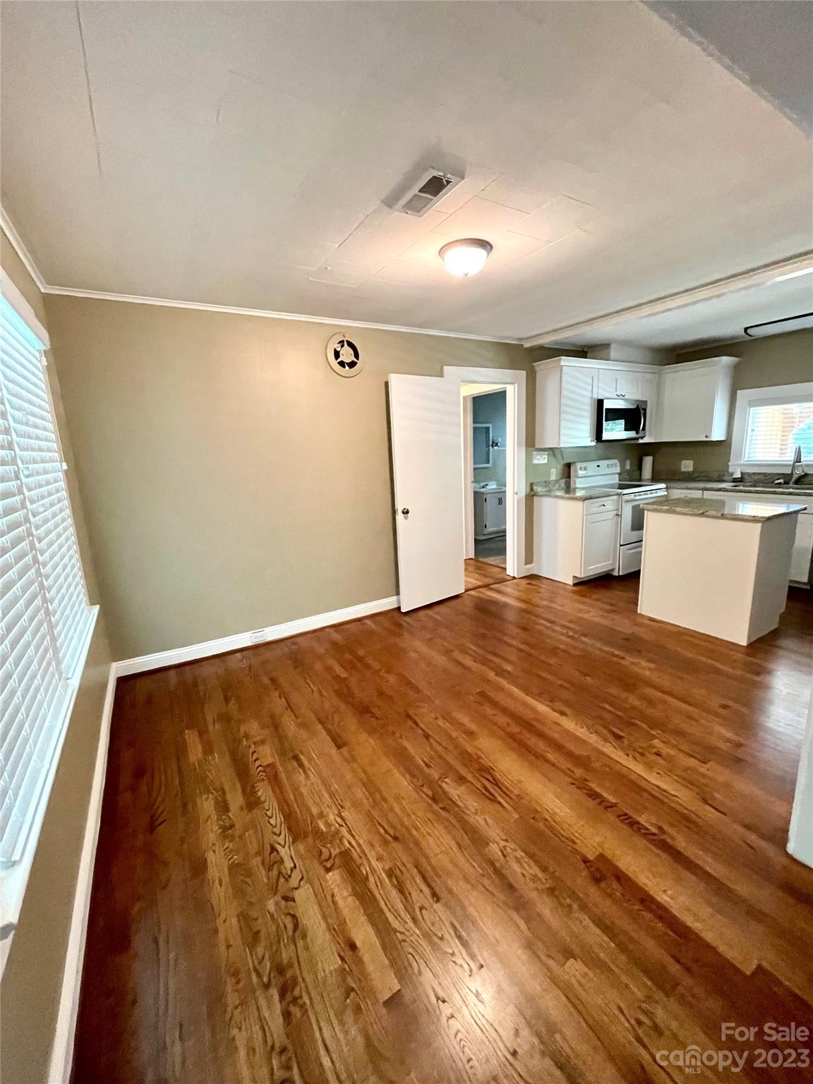 3270 West Innes Street Salisbury, NC 28144 - Photo 12 of 33 a view of kitchen and empty room with wooden floor