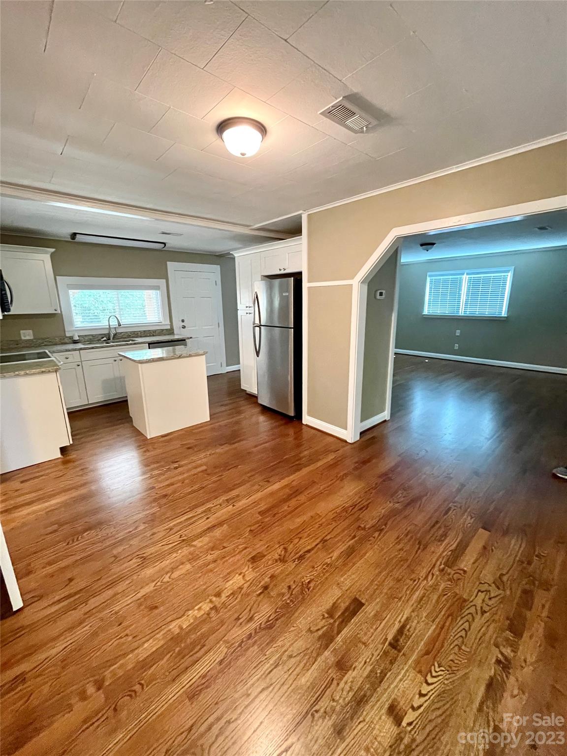 3270 West Innes Street Salisbury, NC 28144 - Photo 13 of 33 a living room with hard wood floors and a kitchen space