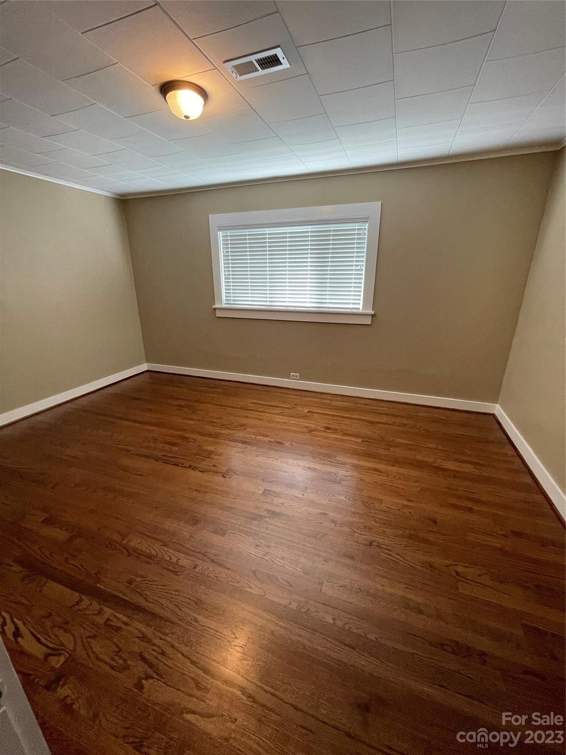 3270 West Innes Street Salisbury, NC 28144 - Photo 20 of 33 an empty room with wooden floor and windows