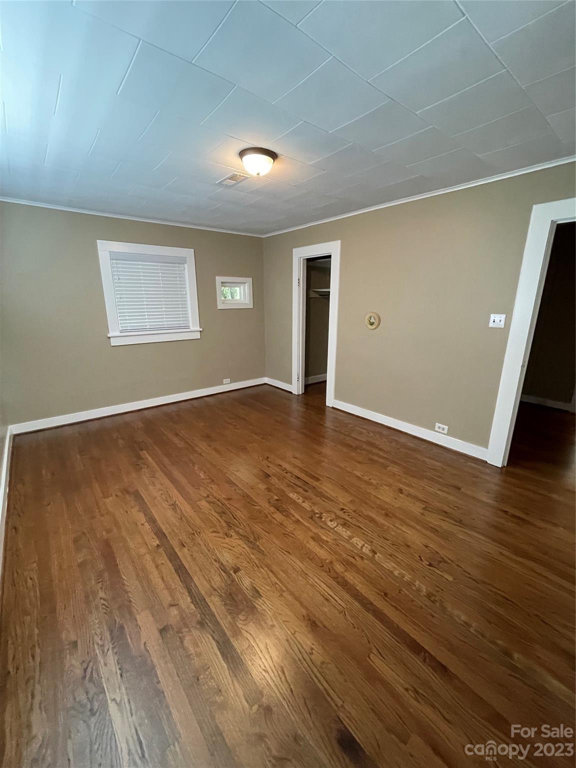 3270 West Innes Street Salisbury, NC 28144 - Photo 21 of 33 an empty room with wooden floor and windows