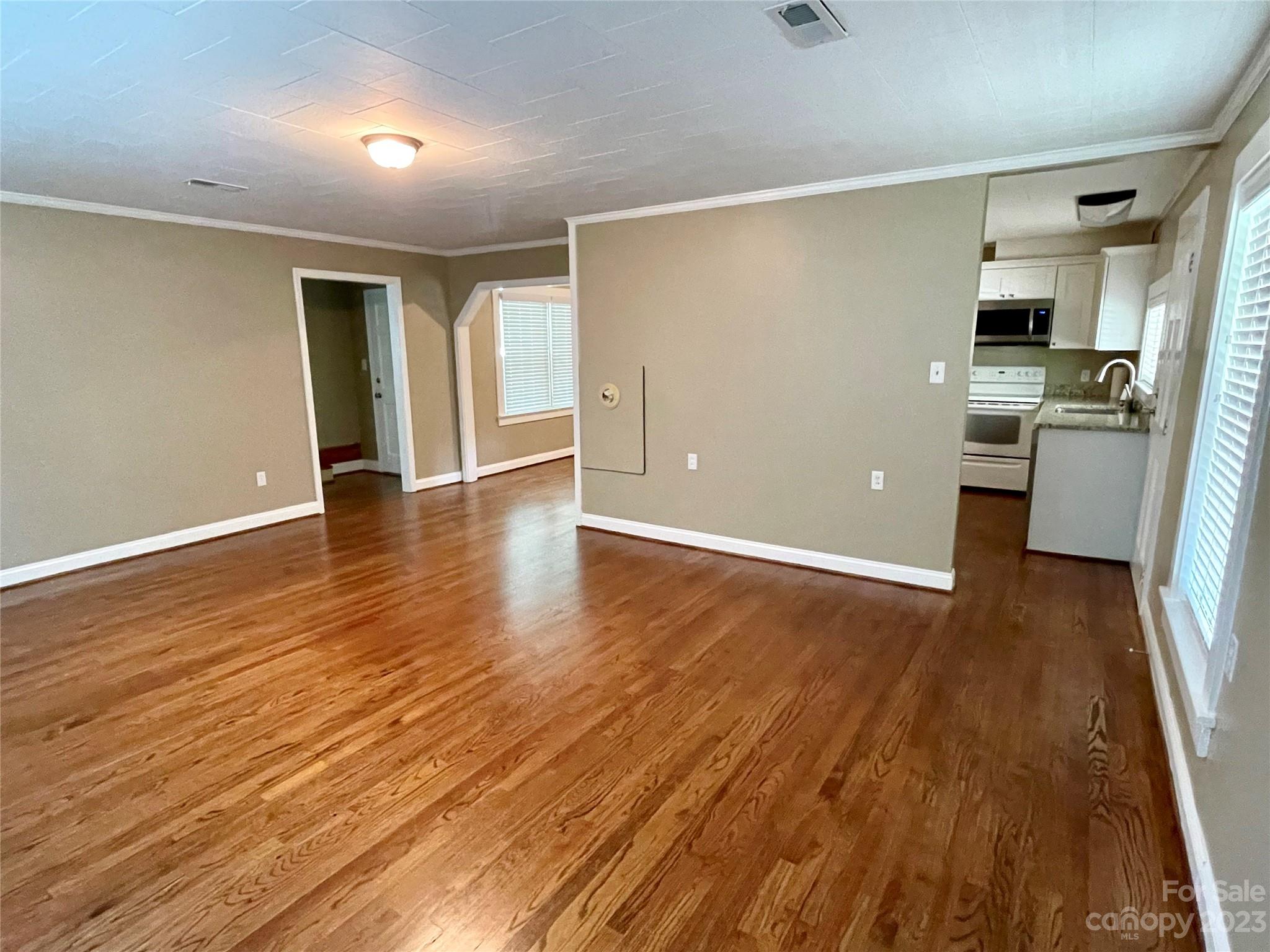 3270 West Innes Street Salisbury, NC 28144 - Photo 25 of 33 wooden floor in an empty room with a kitchen