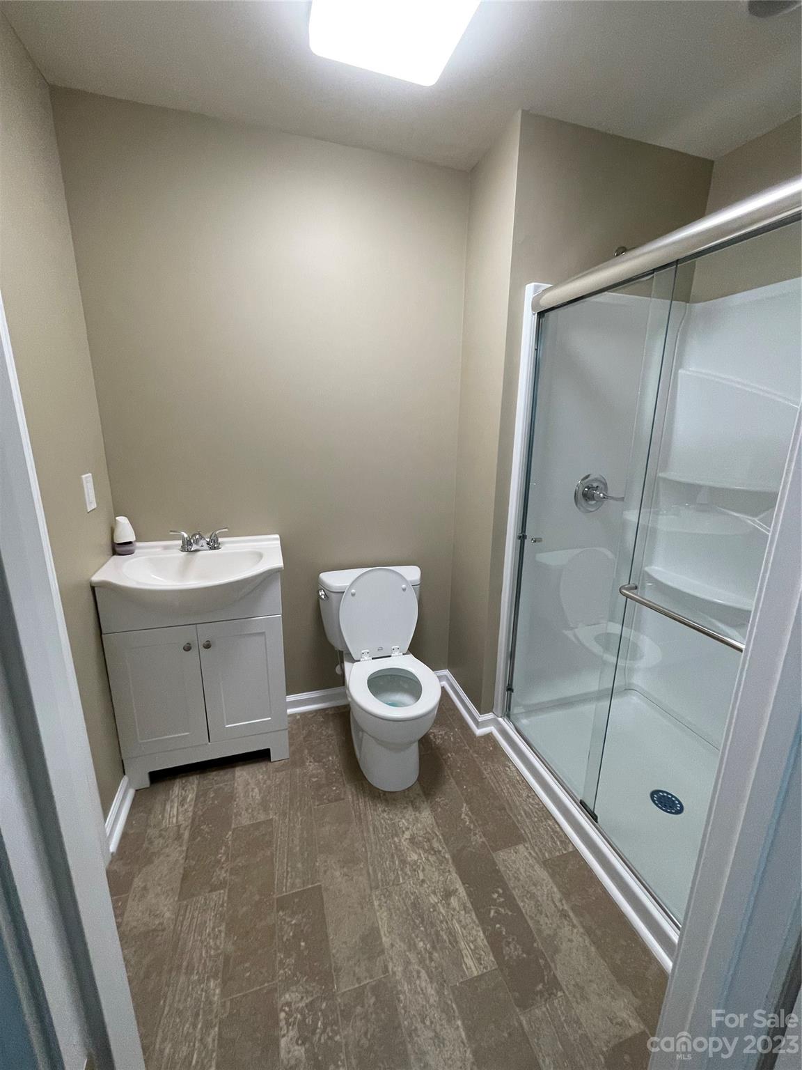 3270 West Innes Street Salisbury, NC 28144 - Photo 31 of 33 a bathroom with a granite countertop sink toilet a mirror and shower