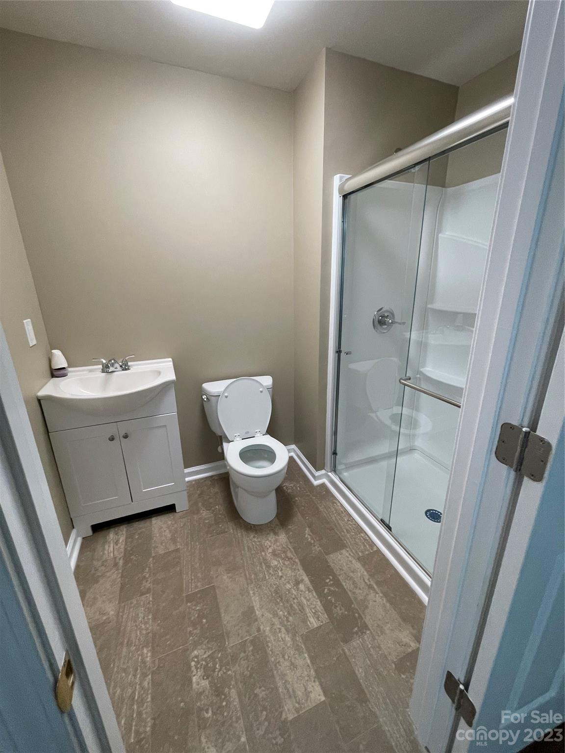 3270 West Innes Street Salisbury, NC 28144 - Photo 32 of 33 a bathroom with a toilet a sink and shower