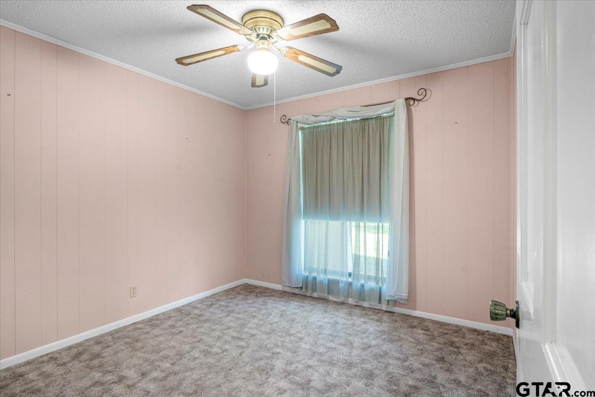 1302 Jeb Stuart Drive Tyler, TX 75703 - Photo 23 of 47 an empty room with windows and fan