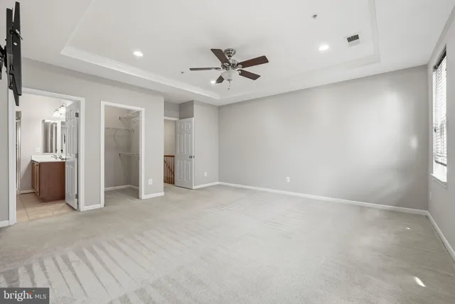 an empty room with a bathroom and a shower