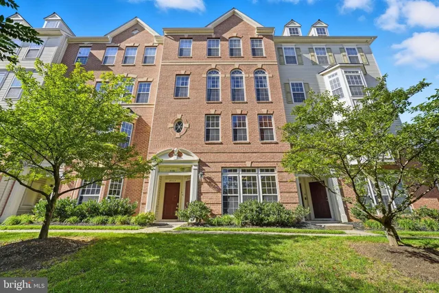 front view of a brick house with a yard