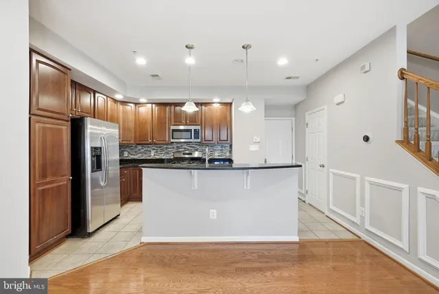 a view of kitchen with stainless steel appliances refrigerator oven