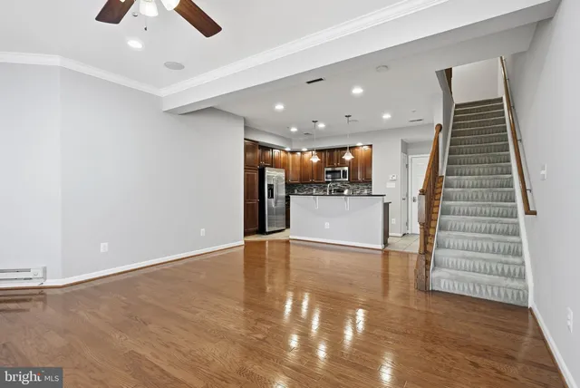 an empty room with wooden floor and entryway