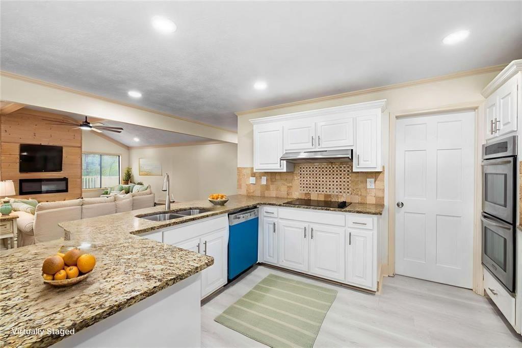 234 Shadow Lake Drive Southwest Lilburn, GA 30047 - Photo 14 of 36 a kitchen with stainless steel appliances granite countertop a sink stove and refrigerator