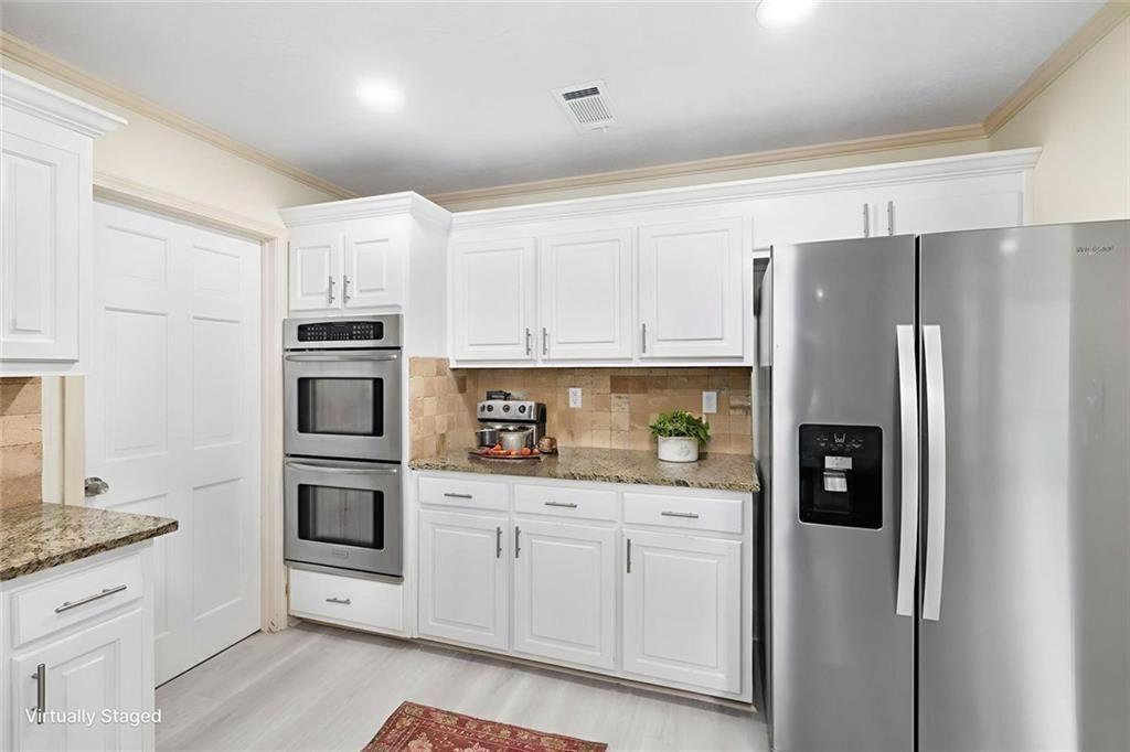 234 Shadow Lake Drive Southwest Lilburn, GA 30047 - Photo 16 of 36 a kitchen with stainless steel appliances a refrigerator sink and microwave