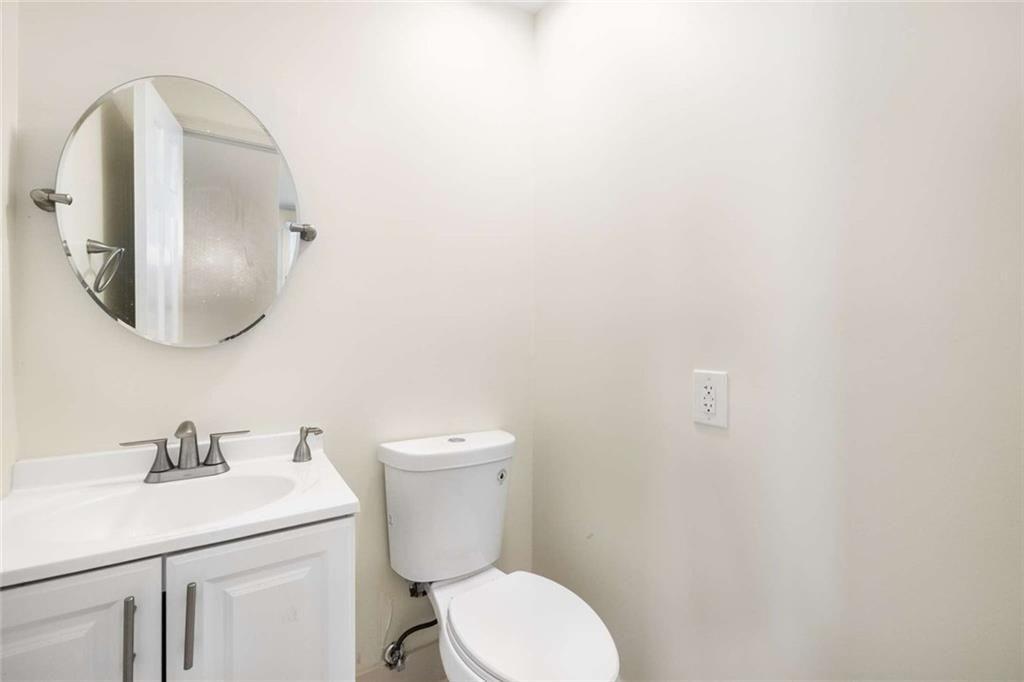 234 Shadow Lake Drive Southwest Lilburn, GA 30047 - Photo 22 of 36 a bathroom with a toilet sink and mirror