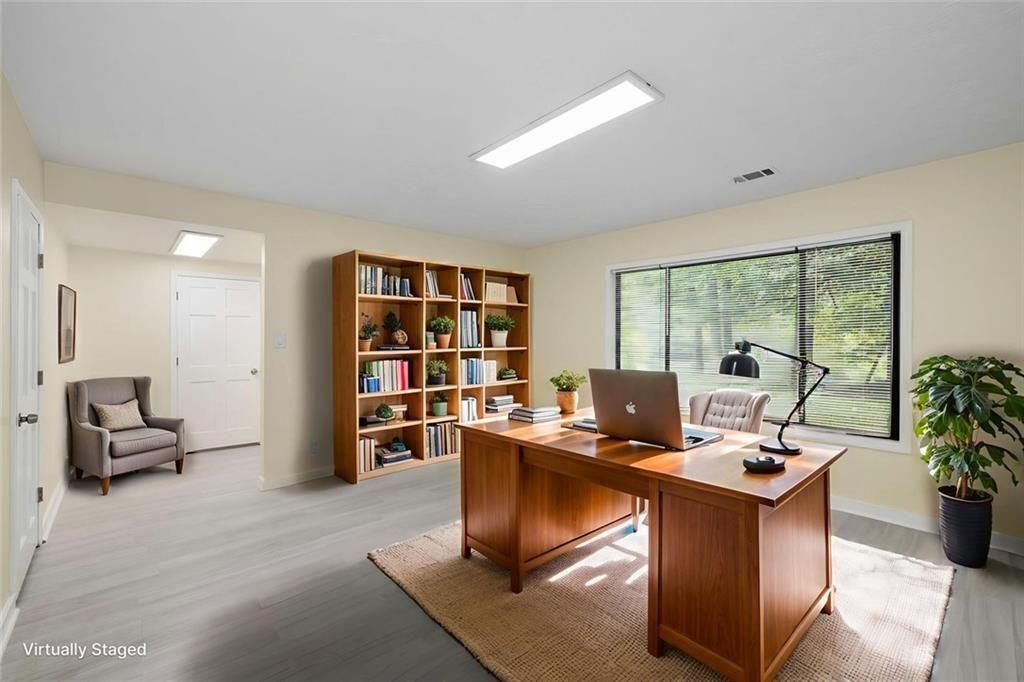 234 Shadow Lake Drive Southwest Lilburn, GA 30047 - Photo 25 of 36 a work room with furniture and a book shelf