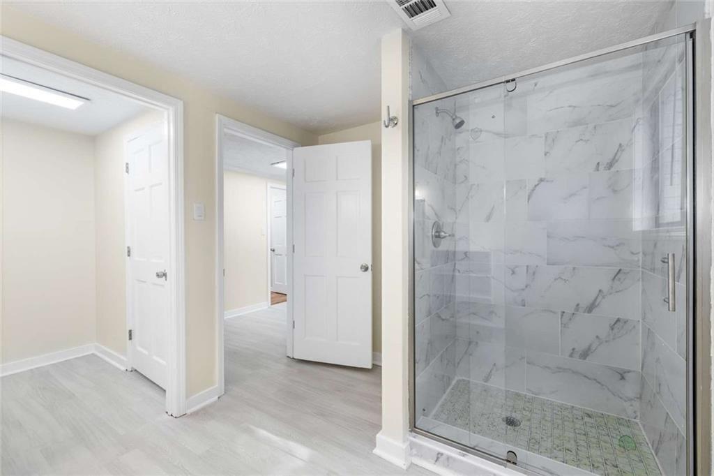 234 Shadow Lake Drive Southwest Lilburn, GA 30047 - Photo 28 of 36 a bathroom with a shower