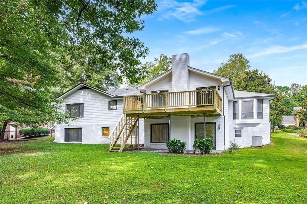 234 Shadow Lake Drive Southwest Lilburn, GA 30047 - Photo 35 of 36 a front view of a house with a garden and trees