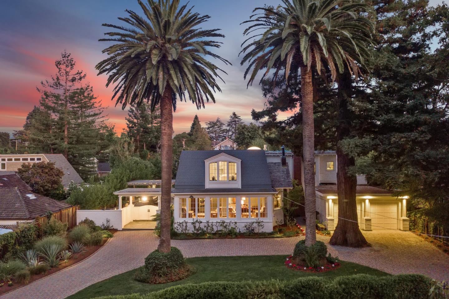 a sign that is sitting in front of a house with a yard