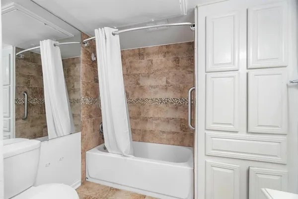 a bathroom with a bathtub and a shower