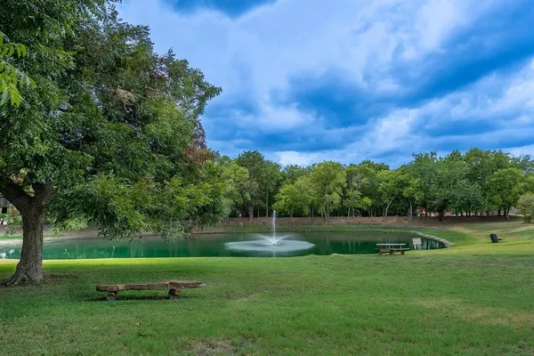 a view of a house with pool and chairs