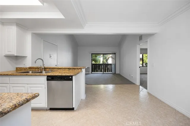 a kitchen with granite countertop a sink and a stove