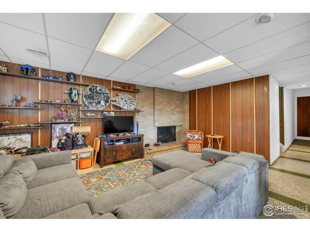 1690 Wilson Court Boulder, CO 80304 - Photo 27 of 48 a living room with furniture a flat screen tv and a fireplace