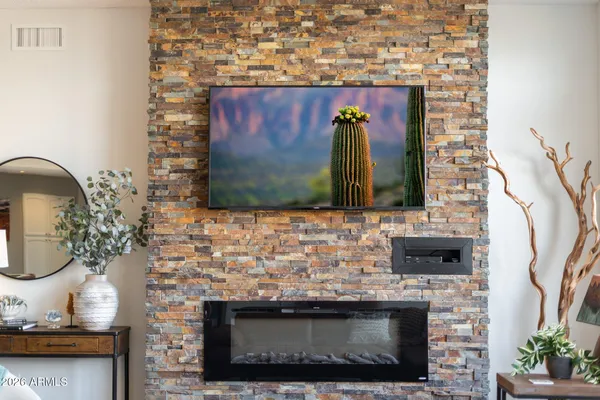 a room with painting on the wall and a window