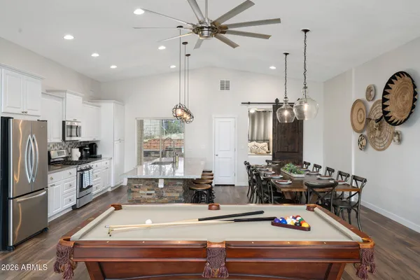 a spacious bathroom with a granite countertop sink mirror and bathtub