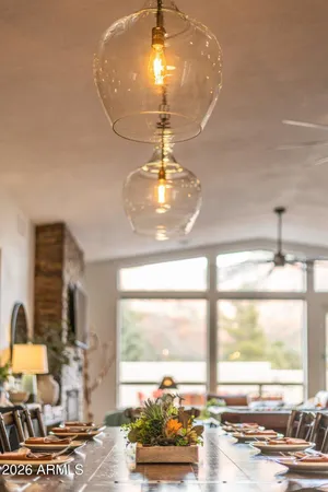 a room with chandelier fan and wooden floor