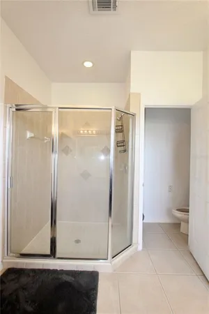 a bathroom with a glass shower door