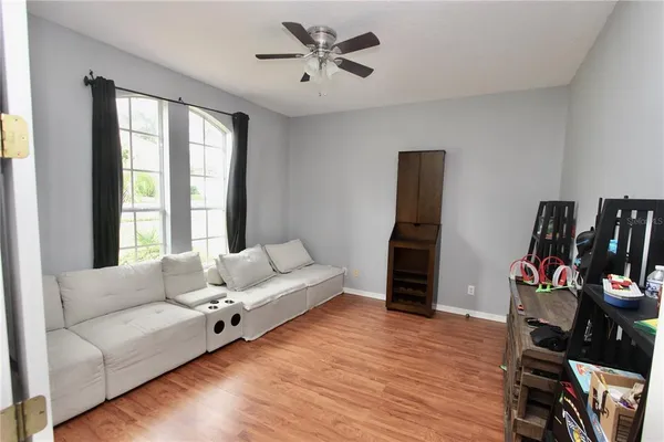 a living room with furniture and wooden floor