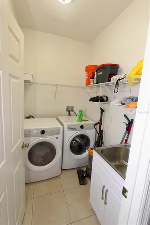 a utility room with sink dryer and washer