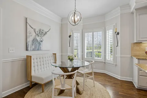 a kitchen with stainless steel appliances granite countertop a refrigerator a stove and a sink with wooden floors