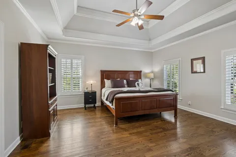 a bathroom with a white tub shower vanity and a sink
