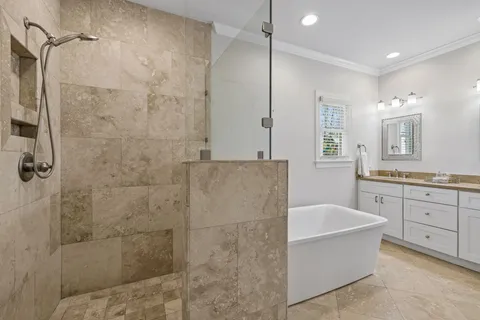 a bathroom with a granite countertop double vanity sink and a mirror