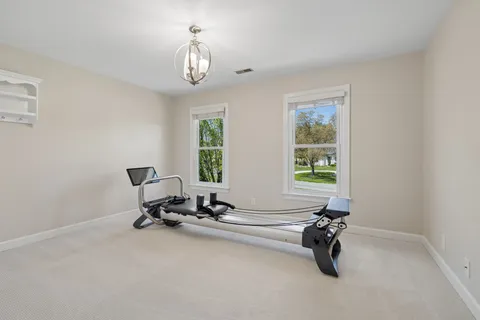 a living room with furniture ceiling fan and a wooden floor