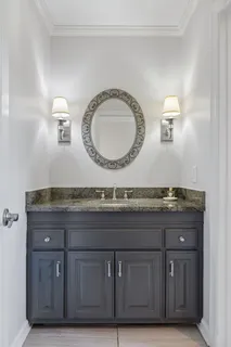 a bathroom with a sink a toilet and mirror