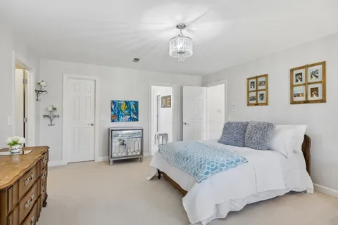 a view of a swimming pool with chairs and a table