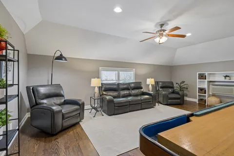 a view of backyard with swimming pool and seating space