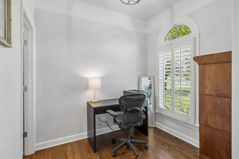 a view of a dining room with furniture a chandelier and wooden floor