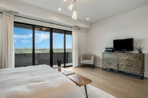 a bedroom with furniture and flat screen tv