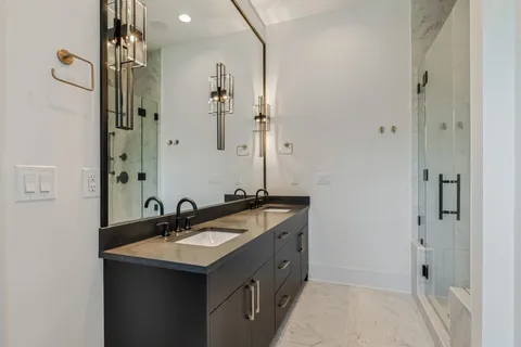 a bathroom with a sink double vanity and a mirror