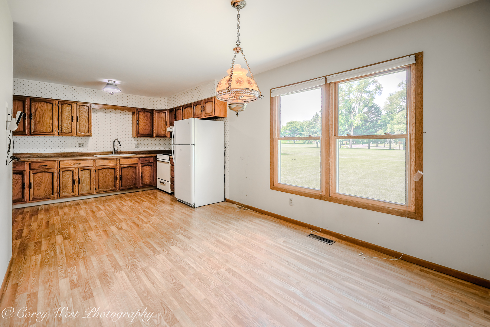 335 South Hadsall Street Genoa, IL 60135 - Photo 10 of 23 a large kitchen with granite countertop a stove a sink dishwasher and a refrigerator with wooden floor
