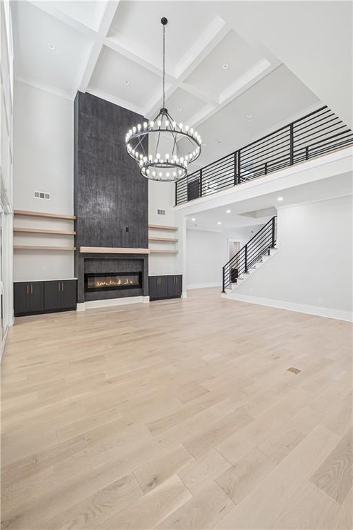 333 Sims Bridge Road Commerce, GA 30530 - Photo 16 of 71 a view of a livingroom with a fireplace a chandelier and stairs