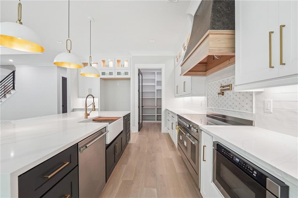 333 Sims Bridge Road Commerce, GA 30530 - Photo 21 of 71 a kitchen with stainless steel appliances a sink a stove and a wooden floors