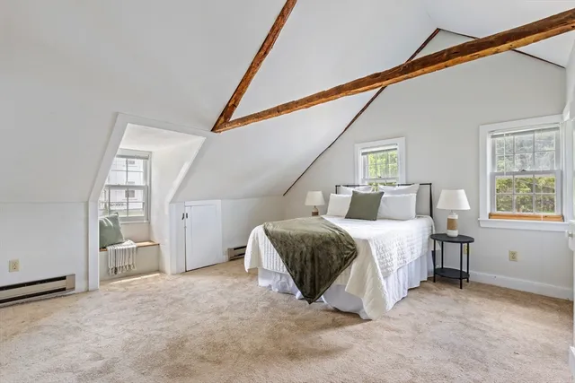 a spacious bedroom with a bed next to a window