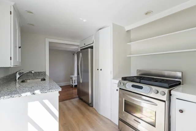 a kitchen with granite countertop a stove and a sink