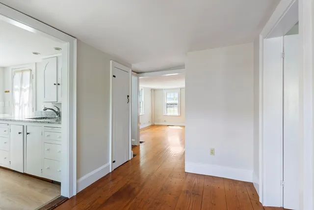 a view of walk in closet with wooden floor