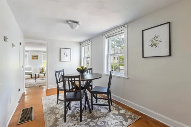 a view of a dining room with furniture and a window