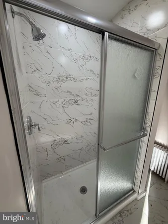 a bathroom with a glass shower door and a sink