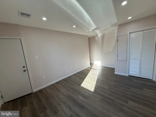 a view of wooden floor and windows in an empty room
