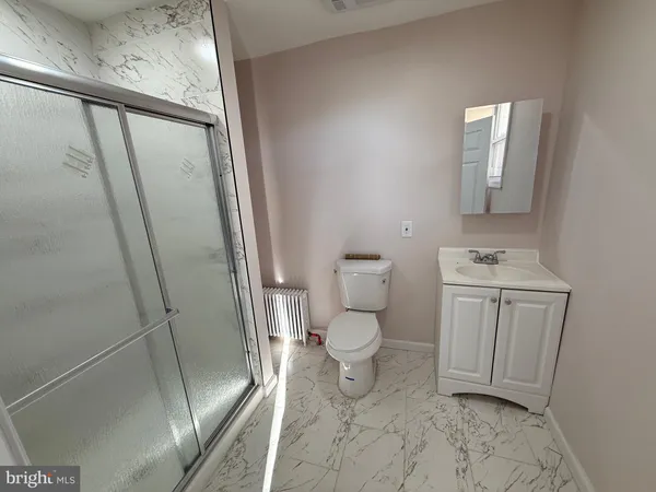 a bathroom with a sink a toilet and a mirror