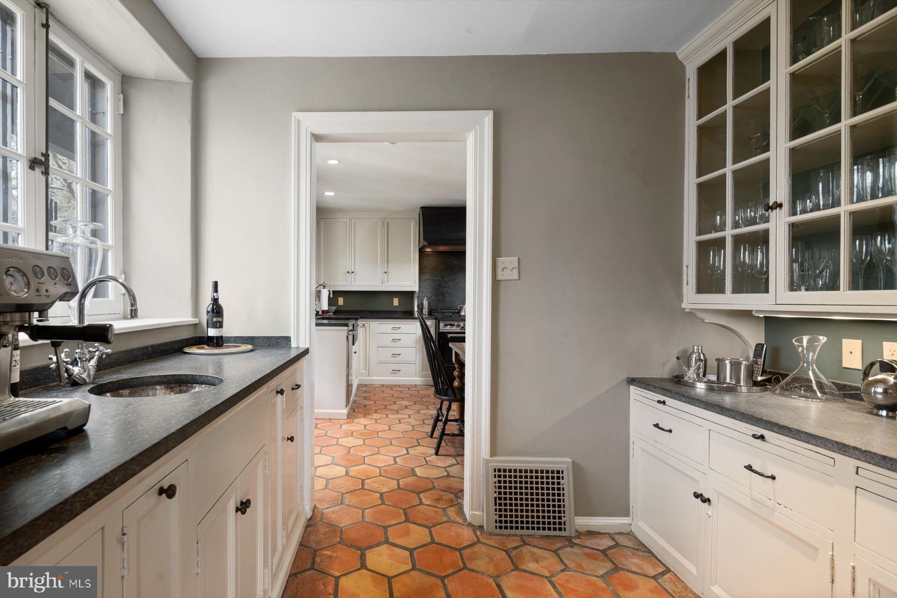 95 West Hampton Road Philadelphia, PA 19118 - Photo 14 of 37 a kitchen with kitchen island granite countertop a sink stove and cabinets